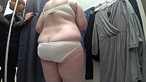 A hidden camera in the changing room peeps at a mature bbw with a big ass and natural boobs.